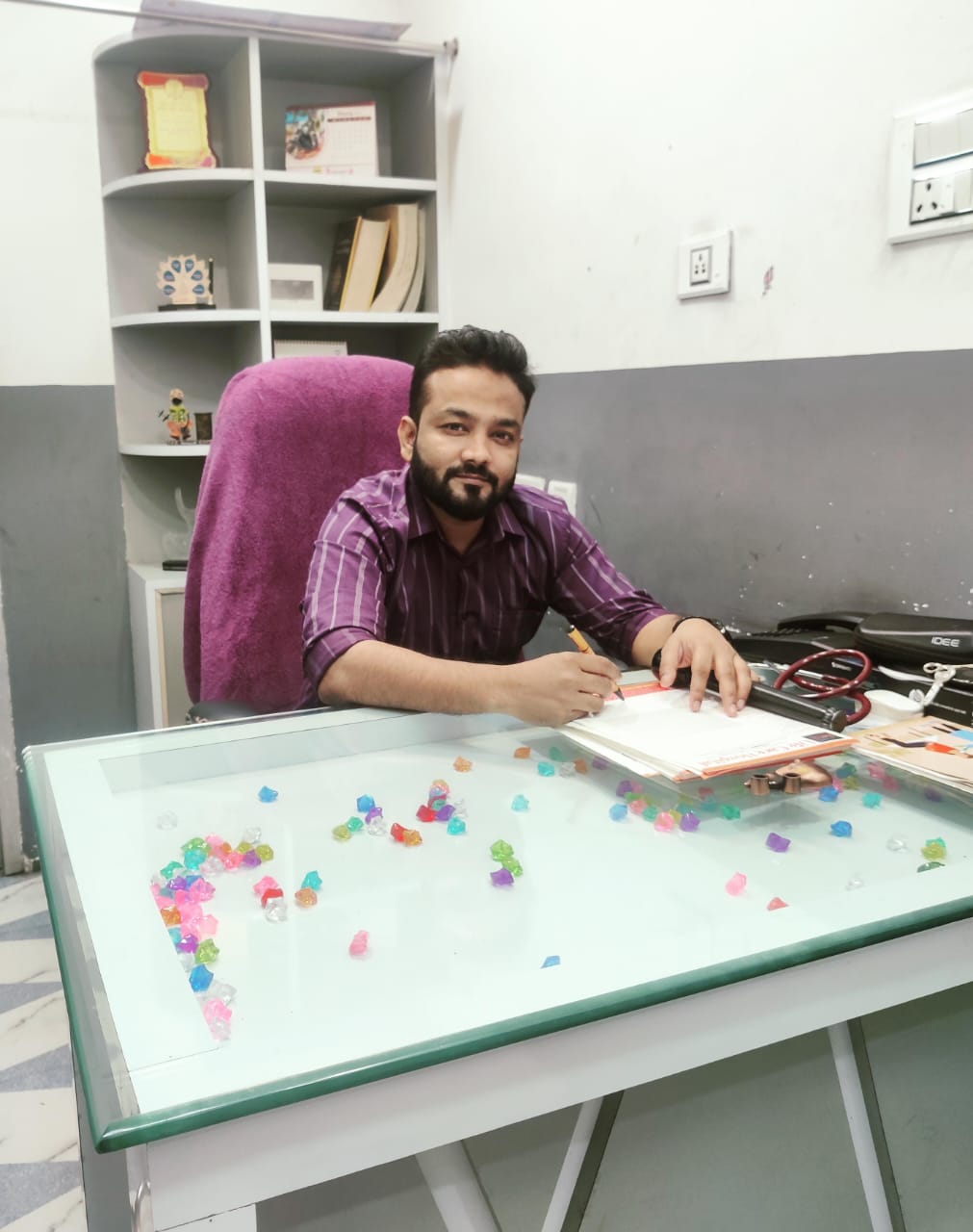 Dr. Arphool Khan at his desk